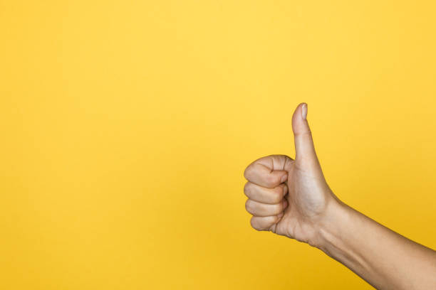 istock Hand of client show thumb up on yellow background, satisfaction concept, copy space for design 1199747823