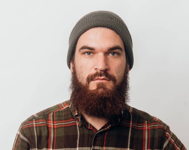 istock Portrait of serious bearded man over white background 1199749563