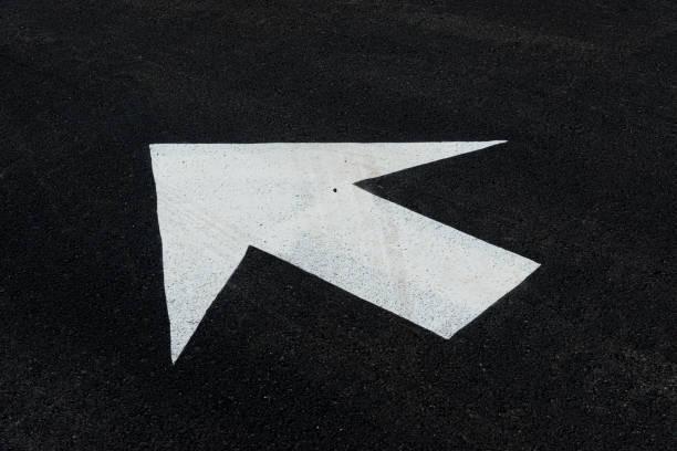 istock Arrow On Parking Lot Pavement With Copy Space 1199749751