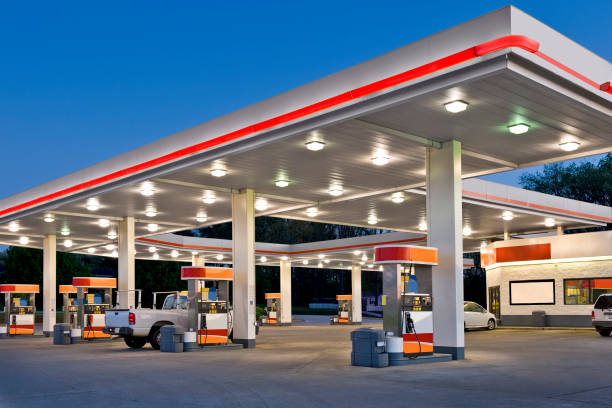 Retail Gasoline Station and Convenience Store REWORKED Horizontal shot of a retail gasoline station and convenience store at dusk. station stock pictures, royalty-free photos & images