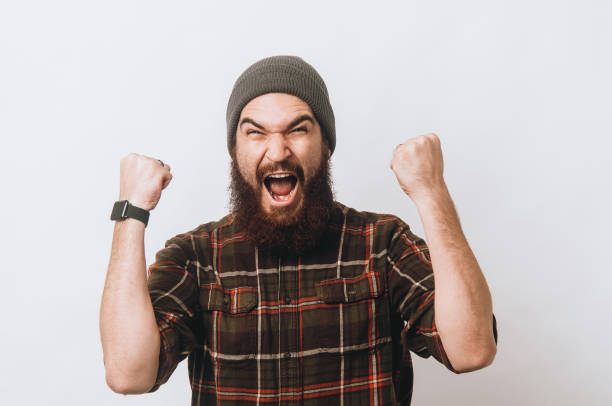 istock Amazed young bearded hipster man screaming over white background 1199749958