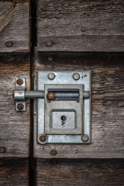 istock Ancient closed sliding bolt lock on a wooden door 1199750656