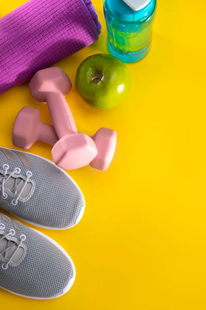 istock Exercise equipment on a yellow background 1199750753