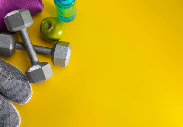 istock Exercise equipment on a yellow background 1199750757