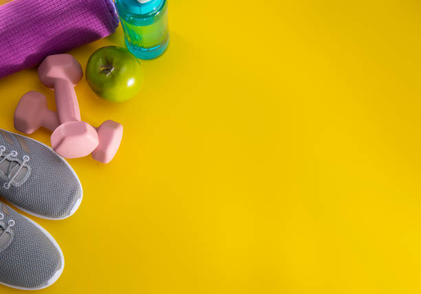 istock Exercise equipment on a yellow background 1199750759