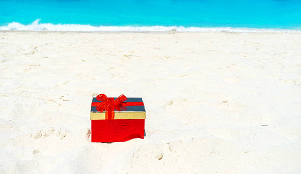 istock Red gift box on the sea sand. Gift concept for Valentine Day. 1199752759