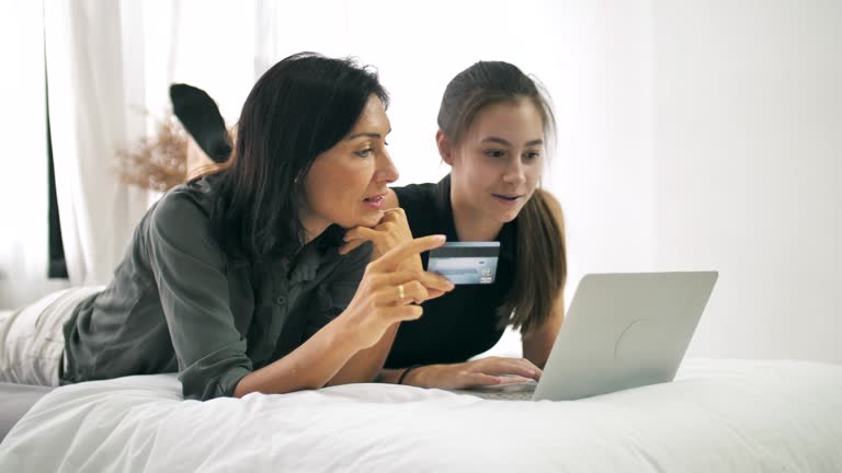 Mother with daughter Online shopping at home