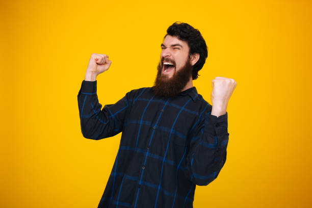 istock Bearded hipster making a winner gesture and screaming. Win concept. 1199758640