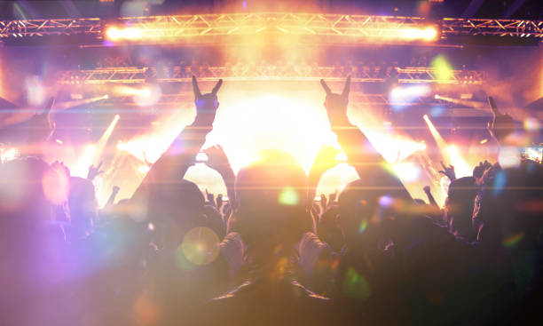 istock Vibrant concert image showing people having fun during a music show 1199760488