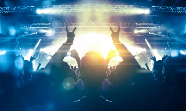 istock Vibrant concert image showing people having fun during a music show 1199760490