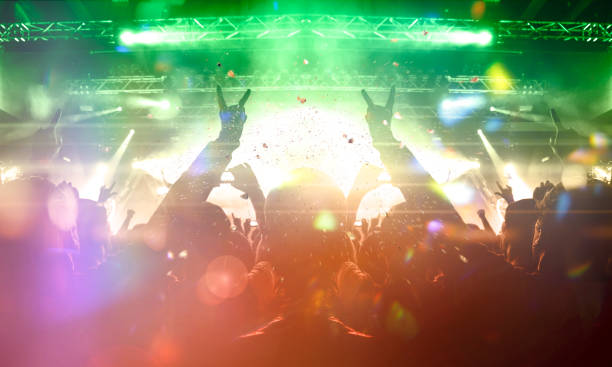 istock Vibrant concert image showing people having fun during a music show 1199760500