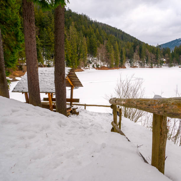 istock Wooden arbor in a snow-covered forest. 1199762509