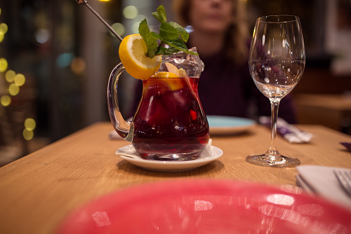 Pitcher of red wine with fruits on a table during diner in restaurant in Spain