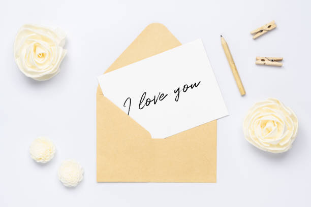 istock Mockup postcard and envelope on white background with craft flower. Mock up for elegant design. Flat lay top view valentine`s day background concept. 1199770219