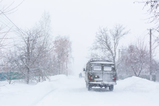 istock The car rides on a snowy highway. Difficult weather conditions. 1199770274