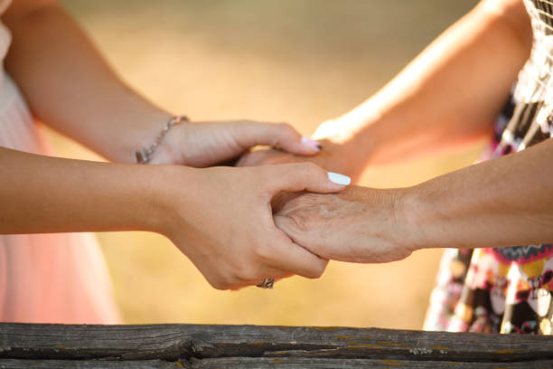 istock Closeup people hold hands of each other 1199771633