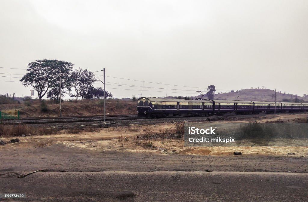 RUNNING TRAIN IN NON TROPICAL PLACE OF INDIA RUNNING TRAIN IN NON TROPOICAL PLACE OF INDIA Asia Stock Photo