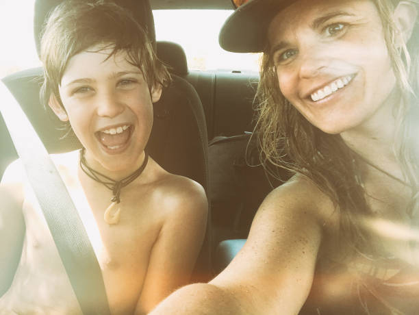 istock Single mom selfies with 10 year old son in a car. 1199773793