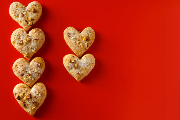 istock Heart shaped sugar cookies on red background. 1199774026