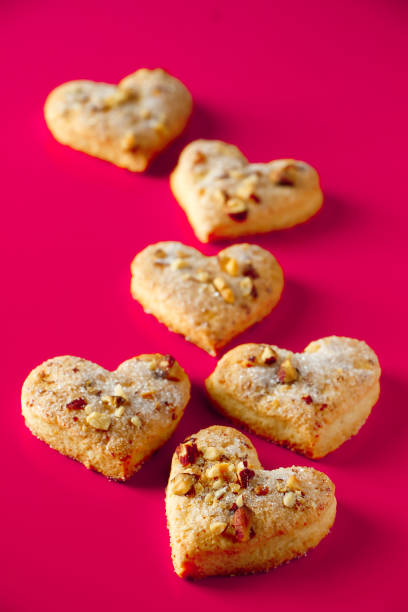 istock Heart shaped cookies for valentines day on a pink background. 1199774072