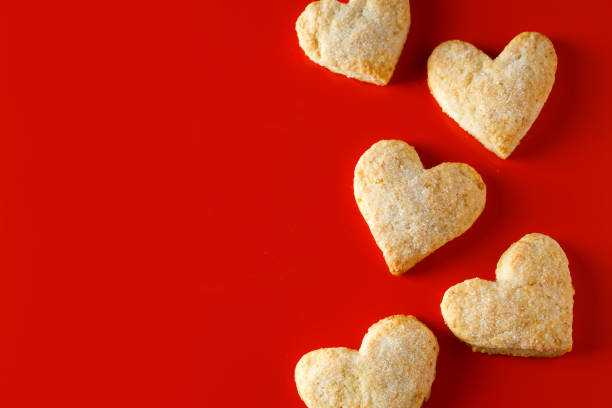 istock Heart shaped sugar cookies on red background. 1199774190