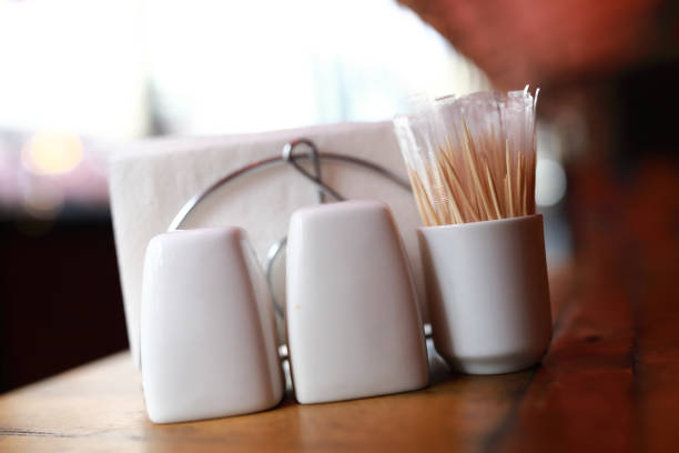Salt with pepper shakers and toothpicks on table in restaurant