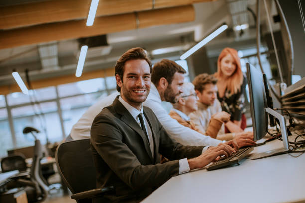 istock Group of young business people are working together with desktop computer 1199777313