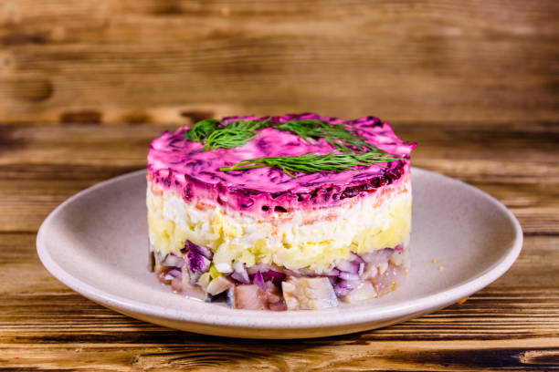 istock Ceramic plate with russian traditional new year salad herring under fur coat (shuba) and on rustic wooden table 1199777351