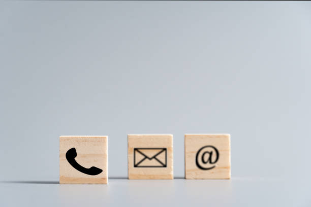 istock contact us icon (phone, email, mail ) on wood cube, customer service and support concept 1199778566