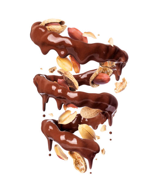 istock Chocolate splashes in spiral shape with crushed peanuts, isolated on a white background 1199778663