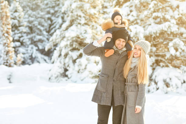 istock Family smiling in winter in a park 1199778940