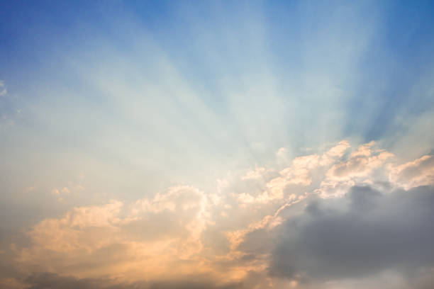 Sunbeam of the sun behind the clouds , sky background