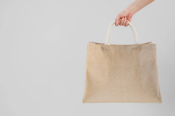 istock Woman hand holding sackcloth shopping bag with copy space No plastic bag concept 1199779136