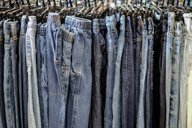 istock Row of hanged blue jeans pants in shop 1199779139