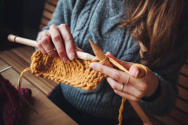 istock Close up on woman's hands knitting 1199780304