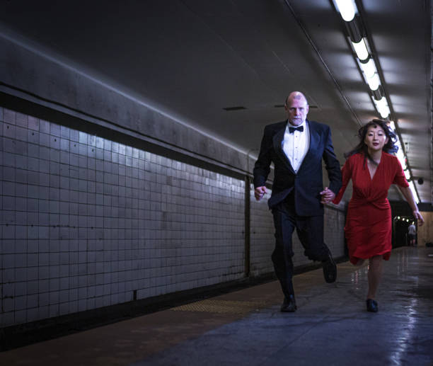 istock Elegant couple running on subway station 1199800558