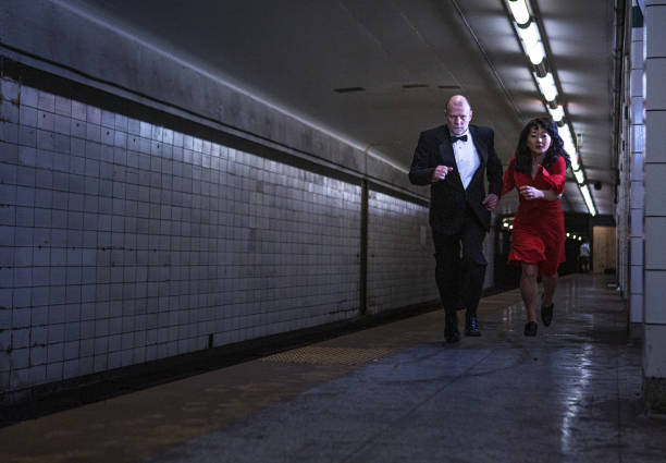 istock Elegant couple running on subway station 1199800632