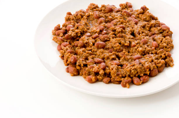 istock Chili con carne on a white plate on white background 1199801478