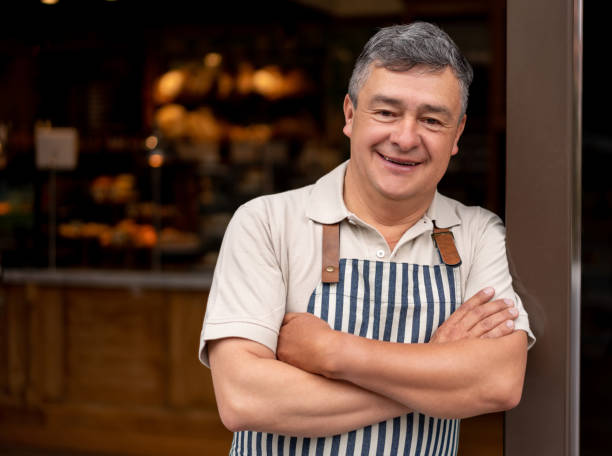 istock Happy waiter working at a cafe 1199801884