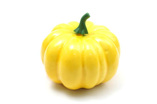 Yellow artificial pumpkin isolated on white background