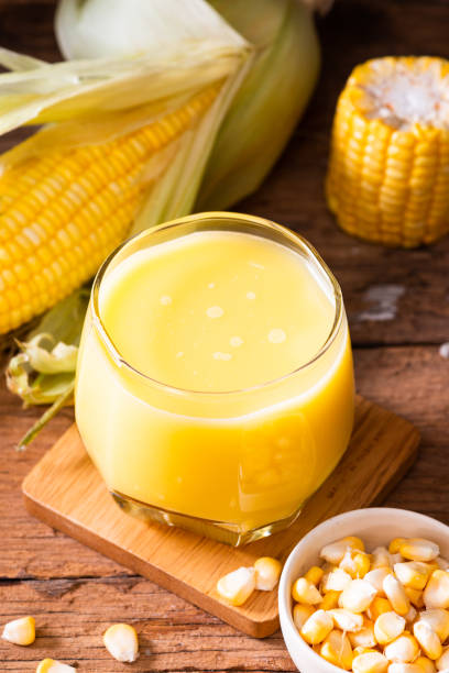 Fresh sweet corn juice (corn milk) and corn on wooden background