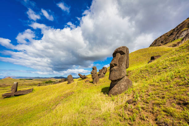 Rapa Nui Rano Raraku Moai Statues Easter Island Rano Raraku Easter Island Moai Statues under sunny summer cloudy sky. Rano Raraku, Rapa Nui National Park, Hanga Roa, Easter Island, Isla de Pascua, Polynesia, Chile, Oceania moai statue rapa nui stock pictures, royalty-free photos & images