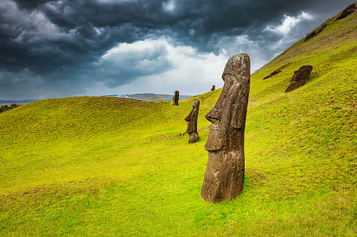 Easter Island Moai Statues at Rano Raraku under dramatic skyscape. Rano Raraku, Rapa Nui National Park, Hanga Roa, Easter Island, Chile.