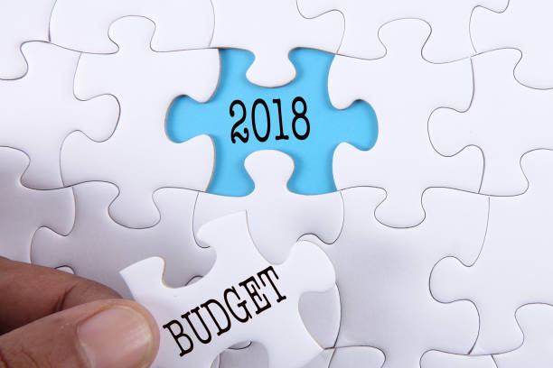 istock Business concept: Missing jigsaw puzzle with word BUDGET 2018. 1199805660