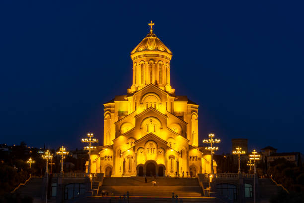 istock Famous Orthodox Holy Trinitiy Sameba church illuminated with golden light. 1199806589