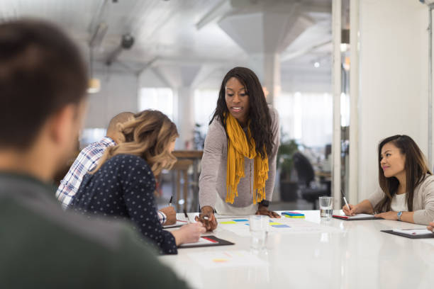 istock Black female CEO leads a team meeting 1199807877