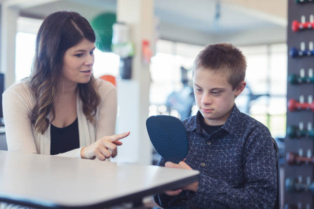 istock Speech therapist works with a young boy 1199808547