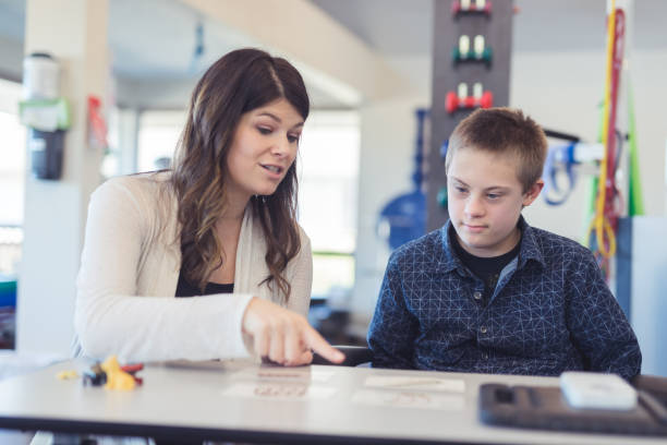 istock Speech therapist works with a young boy 1199808548