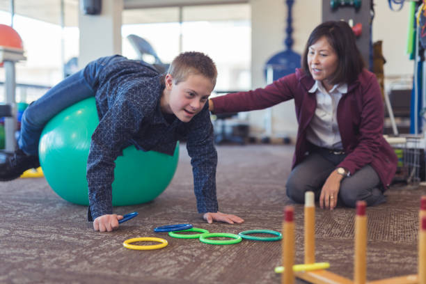 istock A boy does workouts with an occupational therapist at a physiotherapy clinic 1199808551