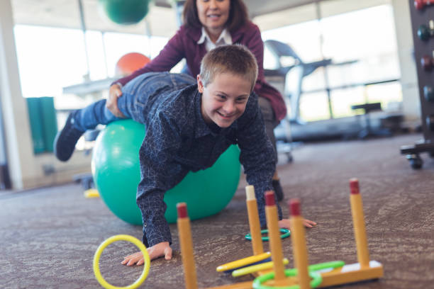 istock A boy does workouts with an occupational therapist at a physiotherapy clinic 1199808553